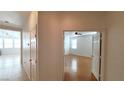 Hallway with light walls and wood flooring leading to bedroom at 3317 Barada Heights Ave, North Las Vegas, NV 89081