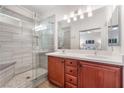 Bathroom with double vanity, large shower, and modern tile at 3952 Moon Tango St, Las Vegas, NV 89129