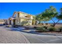 Exterior view of a two-story home with desert landscaping and stone pavers at 4 Via Centrale # 3, Henderson, NV 89011