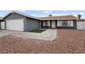 Gray house with a two-car garage and landscaped front yard at 4083 Eileen St, Las Vegas, NV 89115