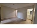 Neutral bedroom featuring wood-style flooring and adjacent bathroom and closet doors at 413 N Lamb Blvd # E, Las Vegas, NV 89110