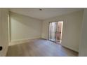 Neutral bedroom featuring wood-style flooring and sliding glass doors at 413 N Lamb Blvd # E, Las Vegas, NV 89110