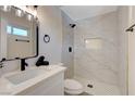 Elegant bathroom with a tiled shower, modern fixtures, and a vanity with quartz countertop at 4512 Mark Ave, Las Vegas, NV 89108