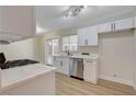 Bright kitchen with stainless steel appliances, white cabinets, and sliding door to backyard at 4512 Mark Ave, Las Vegas, NV 89108