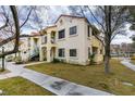 Two-story building with light-colored exterior, landscaping, and walkway at 4869 S Torrey Pines Dr # 101, Las Vegas, NV 89103