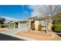 Charming home featuring desert landscaping, a front-facing two-car garage, and a well-maintained exterior at 5468 Carrara Pointe St, Pahrump, NV 89061