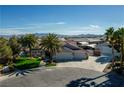 Aerial view of a single-story house with a large yard and palm trees at 5625 W Agate Ave, Las Vegas, NV 89139