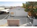 Detached garage with gated entrance, offering secure parking and additional storage space at 5625 W Agate Ave, Las Vegas, NV 89139