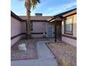 Covered front entrance featuring a security screen door and a xeriscaped yard at 6741 Solaron Ave, Las Vegas, NV 89156