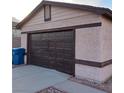 Two car garage with a dark brown garage door at 6741 Solaron Ave, Las Vegas, NV 89156