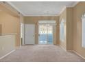 Living room with neutral carpet, sliding doors, and plenty of natural light at 700 Carnegie St # 3711, Henderson, NV 89052