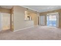 A view of the living room, leading into the kitchen, with a view of the bathroom to the left at 700 Carnegie St # 3711, Henderson, NV 89052