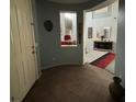 Front door leading to an entryway with a view into a living room and staircase at 7511 Shadow Estates Way, Las Vegas, NV 89113