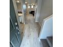 Bright entryway with light-colored wood-look flooring and stairs leading upstairs at 7732 Hand Woven Ct, Las Vegas, NV 89149