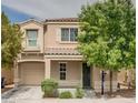 Inviting two-story home with a well-manicured lawn, covered porch, and attached garage, perfect for Gathering living at 7732 Hand Woven Ct, Las Vegas, NV 89149