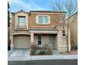 Charming two-story home featuring a well-kept front yard, a cozy porch, and an attached garage at 7732 Hand Woven Ct, Las Vegas, NV 89149