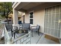 Cozy front porch featuring a seating area with chairs and a table, perfect for relaxing outdoors at 7732 Hand Woven Ct, Las Vegas, NV 89149