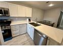 Modern kitchen with stainless steel appliances, white cabinets, and sleek countertops at 7732 Hand Woven Ct, Las Vegas, NV 89149