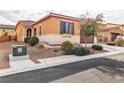 Single story house with tan exterior and two car garage at 825 Great Sky Ct, North Las Vegas, NV 89084