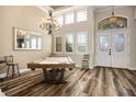 Bright entryway featuring a chandelier, a games table, and double doors with decorative glass at 2012 Poetry Ave, Henderson, NV 89052