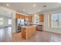 Bright kitchen featuring a center island, stainless steel appliances, tile flooring and lots of natural light at 2301 Bahama Point Ave, North Las Vegas, NV 89031