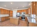 Spacious kitchen with granite countertops, a center island, stainless steel appliances, and ample cabinet space at 2301 Bahama Point Ave, North Las Vegas, NV 89031