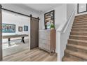 Hallway featuring stairs and sliding barn door at 2827 Blue Mosaic Ln # 3, Las Vegas, NV 89183