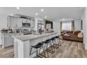 Contemporary kitchen with gray cabinets, granite countertops, stainless steel appliances, and bar stool seating at 2827 Blue Mosaic Ln # 3, Las Vegas, NV 89183