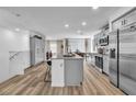 Spacious kitchen with gray cabinets, large island, stainless steel refrigerator, and adjacent dining area at 2827 Blue Mosaic Ln # 3, Las Vegas, NV 89183