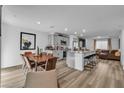 Open concept kitchen with dining area, granite countertops, stainless appliances and bar stool seating at 2827 Blue Mosaic Ln # 3, Las Vegas, NV 89183