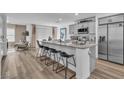 Spacious kitchen featuring a large island with bar seating, stainless steel appliances, and elegant pendant lighting at 2827 Blue Mosaic Ln # 3, Las Vegas, NV 89183