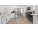 Bright kitchen featuring stainless steel appliances and white cabinetry at 2928 Cape Verde Ln, Las Vegas, NV 89128