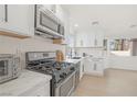 Updated kitchen with stainless steel appliances and quartz countertops at 2928 Cape Verde Ln, Las Vegas, NV 89128
