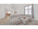 Spacious living room with a large sectional sofa and high ceilings at 2928 Cape Verde Ln, Las Vegas, NV 89128