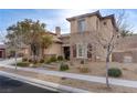 Two-story house with stone and stucco exterior, brown garage doors, and landscaped yard at 37 Carolina Cherry Dr, Las Vegas, NV 89141