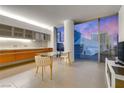 Stylish condo interior with wood cabinets, a modern dining area, and panoramic city views at 3722 Las Vegas Blvd # 305, Las Vegas, NV 89158