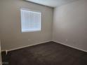 Simple bedroom with dark carpet and window blinds at 3833 Soda Springs Dr, Las Vegas, NV 89115