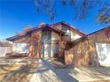 Two-story house with attached garage and mature tree in front yard at 4684 Trevins Ave, Las Vegas, NV 89103