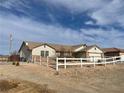 House exterior showcasing a two-car garage and desert landscaping at 520 W Leslie St, Pahrump, NV 89060