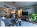 Spacious living room with gray sectional sofa and wood floors at 5261 Lindell Rd # 205, Las Vegas, NV 89118