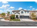 Two-story house with a two-car garage and neatly landscaped yard at 5310 Esparon Ave, Las Vegas, NV 89141