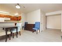 Dining area with glass table and four chairs.Adjacent kitchen at 5493 Indian River Dr # 376, Las Vegas, NV 89103