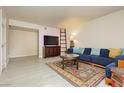 Spacious living room with blue couch and patterned rug at 5493 Indian River Dr # 376, Las Vegas, NV 89103