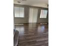 Living room with large windows and hardwood floors at 6225 Dan Blocker Ave # 102, Henderson, NV 89011