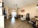 Bright living room with hardwood floors, a comfy couch and access to a patio at 9708 Devenish Ave # 101, Las Vegas, NV 89129