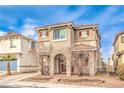 Two-story house with red doors and shutters, landscaping, and a driveway at 1324 Spice Ridge Ct, Henderson, NV 89012