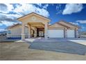 Charming home exterior featuring a covered drive, complemented by a well-manicured front yard at 1771 Labrador St, Pahrump, NV 89048