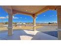 Captivating front view from the covered area, showcasing the lush landscaping and distant mountains at 1771 Labrador St, Pahrump, NV 89048