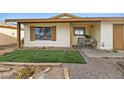 This home features a cozy front porch sitting area, surrounded by low-maintenance landscaping at 204 Cimarron Ct, Henderson, NV 89002