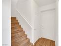 Bright entryway with wood-look floors, staircase, white walls, and a closet at 2050 W Warm Springs Rd # 3322, Henderson, NV 89014